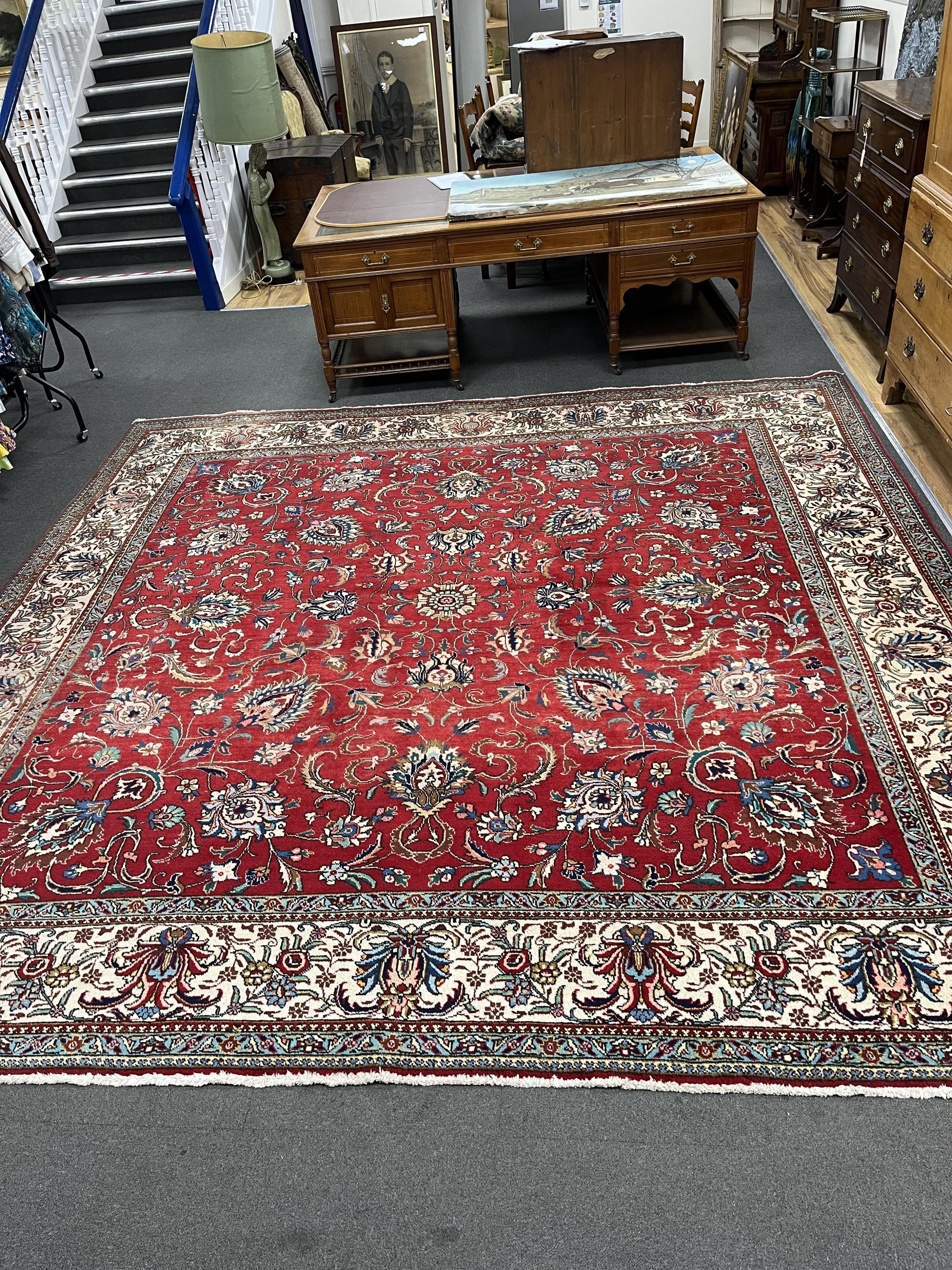 A Persian red ground carpet, worn, 340 x 340cm. Condition - fair